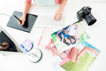 Cropped image of a designer retouching photos using a computer and a graphic digital tablet on the foregroundの写真素材
