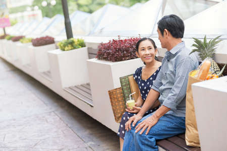 Copy-spaced image of a senior family having rest after shopping on the foregroundの写真素材