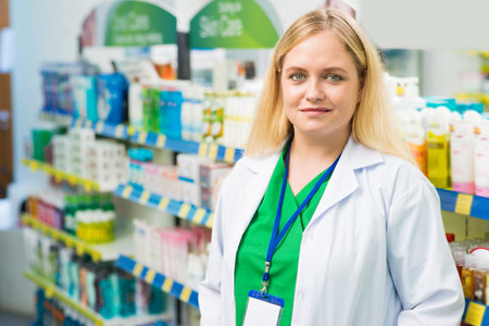 Copy-spaced portrait of a young female pharmacist standing and looking at camera in the drugstore on the foregroundの写真素材