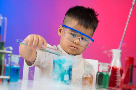 Image of a young researcher making chemical experiments in the labの写真素材