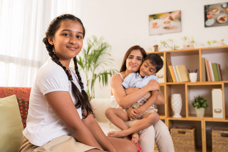 Preteen smiling Indian girl and her family at homeの写真素材