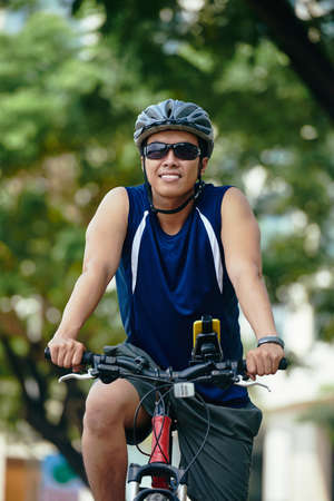 Portrait of cheerful cyclist in helmet and sunglassesの写真素材