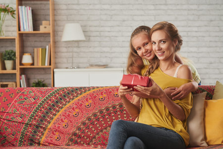 Little girl giving present to her motherの写真素材