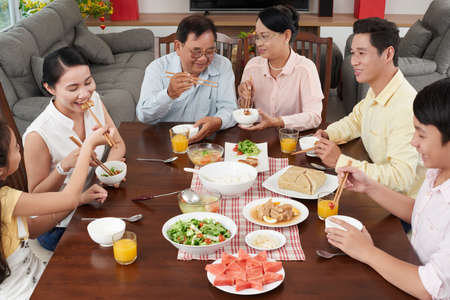 Big Asian family enjoying traditional food for Tet celebrationの写真素材