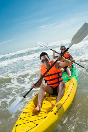 Couple rowing in kayakの写真素材
