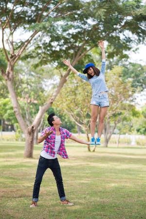 Boy supporting a girl with his handの写真素材