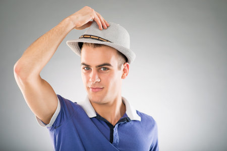 Young man showing his hatの写真素材