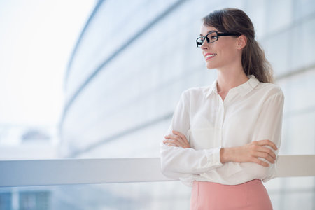 Copy-spaced image of a young cheerful business lady posing at cameraの写真素材