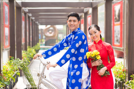 Vietnamese couple in traditional clothes with bicycleの写真素材