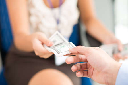 Woman giving money to a manの写真素材