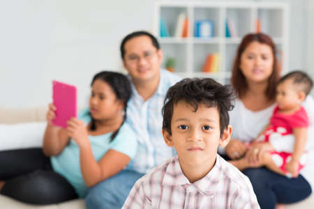 Close-up portrait of a little cute boy looking at camera on the foregroundの写真素材