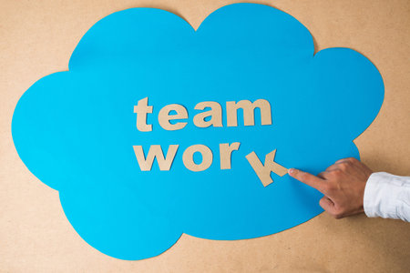 Image of a word ?teamwork? in the blue cloud in the sign of togetherness and unionの写真素材