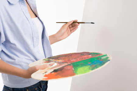 Woman artist holding dirty paletteの写真素材