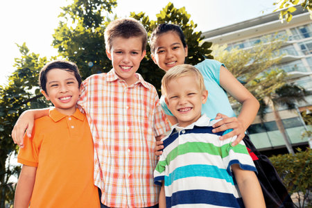 Four smiling children looking at the camera