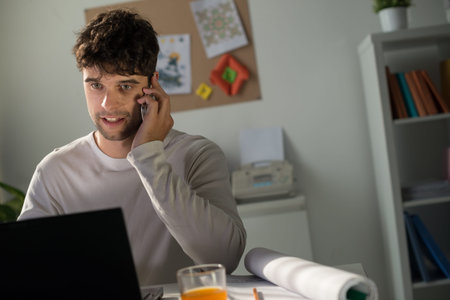 Portrait of young man talking on his smartphone