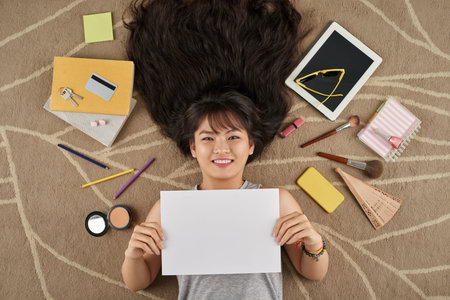 Teenage girl holding blank paper