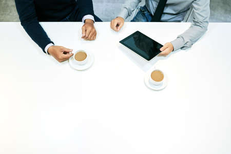 Discussing plans and drinking coffeeの写真素材
