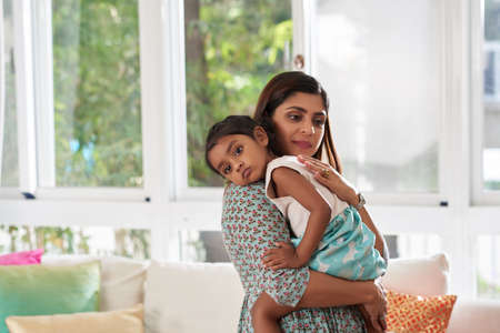 Mother soothing little daughterの写真素材