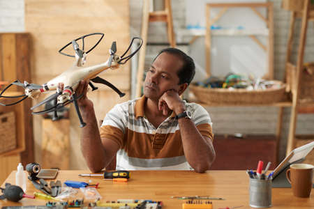 Repairman with drone in workshopの写真素材
