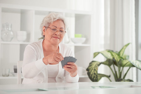 Asian woman pensioner playing cardsの写真素材