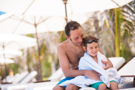 Portrait of man and his son after swimming in the poolの写真素材