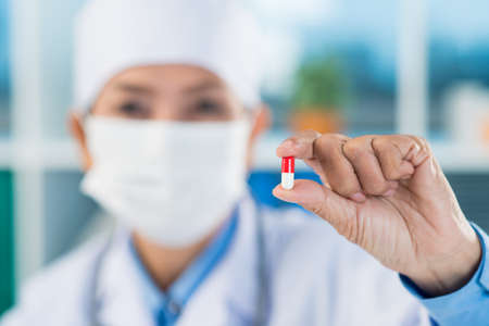 Doctor holding a pillの写真素材