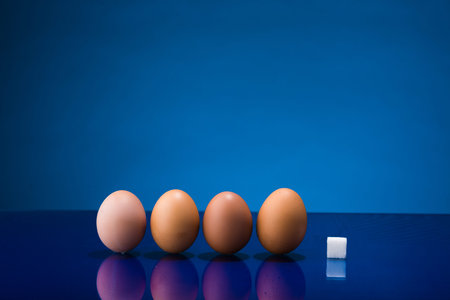 Still life showing amount of sugar in four eggs