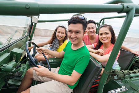 Portrait of four Vietnamese friends having a car tripの写真素材
