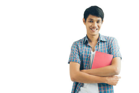 Portrait of handsome Asian male student holding a bookの写真素材