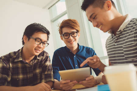 Asian students using digital tablet during the breakの写真素材