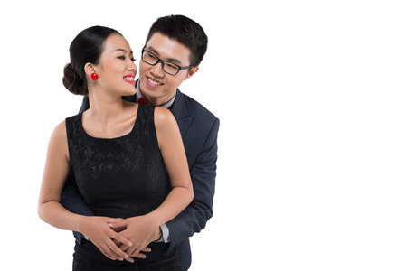 Vietnamese man embracing his beautiful girlfriend from behind