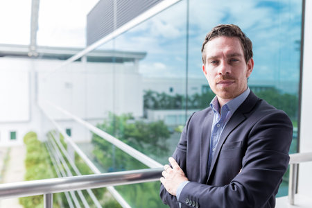 Portrait of confident businessman with folded arms looking at the camera