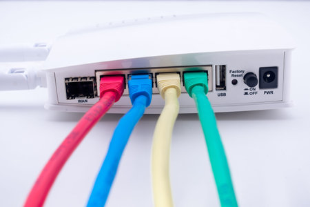 Close-up of internet router with four multicolored cable wiresの写真素材