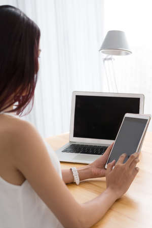 Woman using digital tablet at her work placeの写真素材