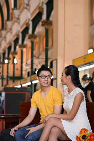 Loving Vietnamese couple on the benchの写真素材