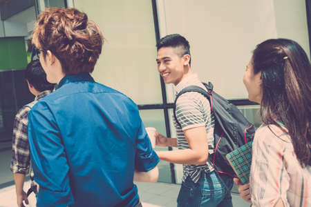 Cheerful students going to schoolの写真素材