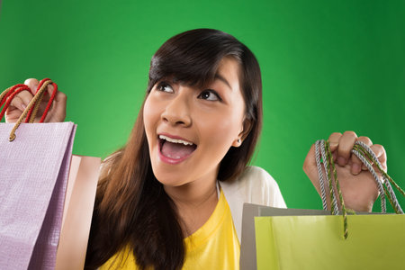 Portrait of excited shopaholic with paper bags