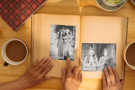 Hand of senior woman pointing at the girl on the black-and-white photoの写真素材