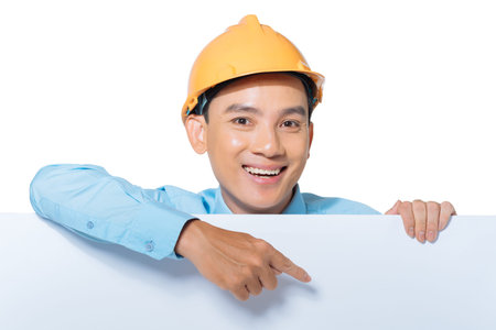 Vietnamese engineer pointing at the white board in his hand