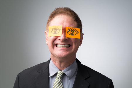 Cheerful businessman or politician with big eyes drawn on stickersの写真素材