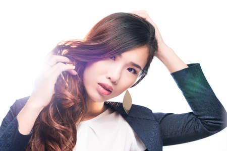 Portrait of beautiful girl touching her long healthy hairの写真素材