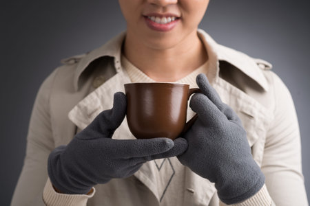 Cropped image of man in warm clothes with a tea cupの写真素材