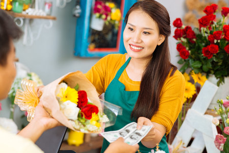 Woman selling flowers to a manの写真素材