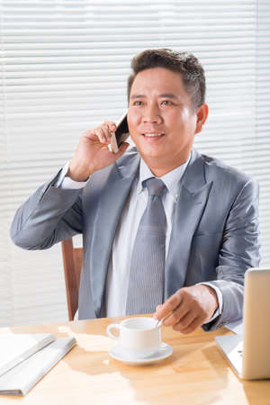 Portrait of businessman talking on the phoneの写真素材