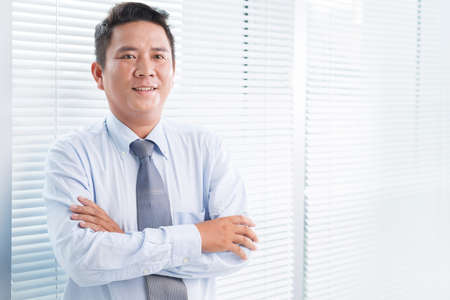 Portrait of a businessman smiling at cameraの写真素材