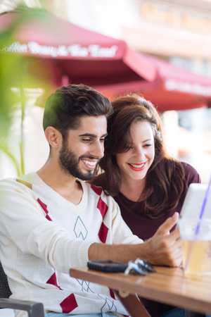 Couple watching something funny on the digital tablet