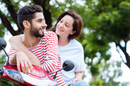Loving couple resting after riding a scooterの写真素材
