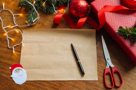 Blank sheet of paper on the table with Christmas decorationsの写真素材
