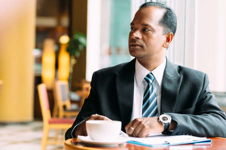 Portrait of serious businessman in the cafeの写真素材