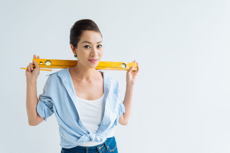 Happy woman posing with spirit levelの写真素材
